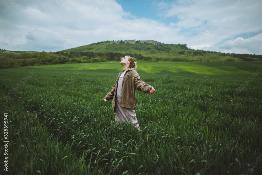 Woman wearing jacket in field in Crimea, Ukraine Woman wearing jacket in field in Crimea, Ukraine