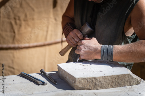 stone craftsman working in his stonekeeping workshop..