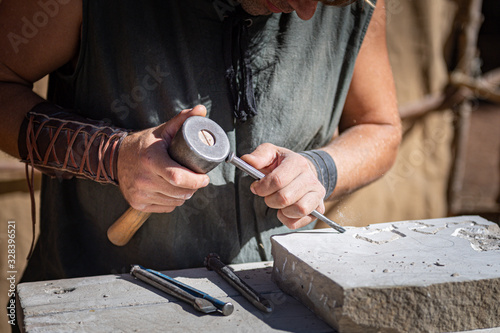 stone craftsman working in his stonekeeping workshop..