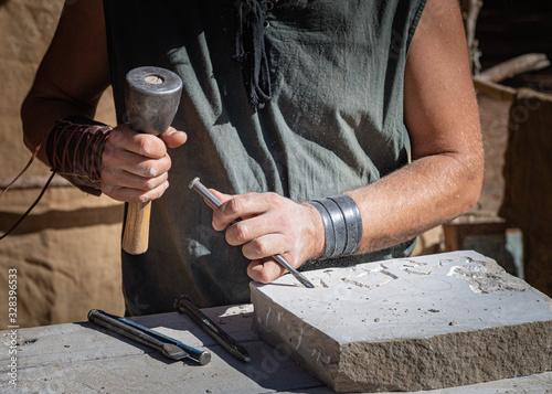 stone craftsman working in his stonekeeping workshop..