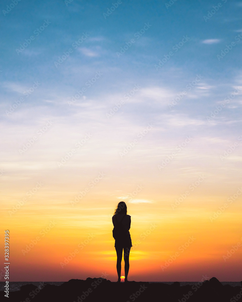 Girl contemplating sunset