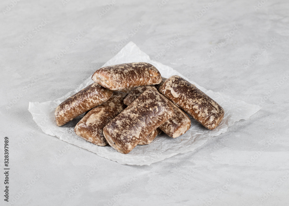 Gingerbread cookies chocolate with icing sugar on a light background Gingerbread cookies chocolate with icing sugar on a light background