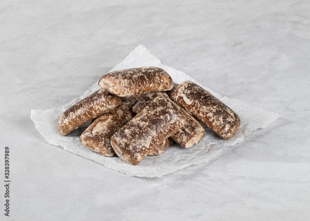 Gingerbread cookies chocolate with icing sugar on a light background