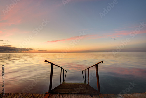 Beautiful view of the evening sea  in the foreground of the stairs descendinto the sea