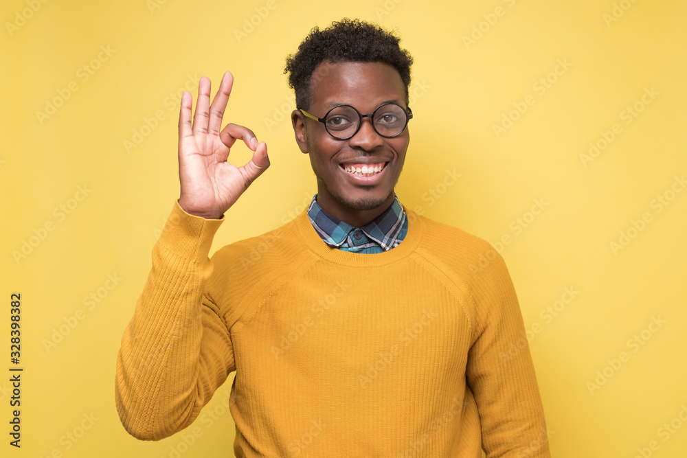 Happy african american black man showing ok sign and smiling Happy african american black man showing ok sign and smiling