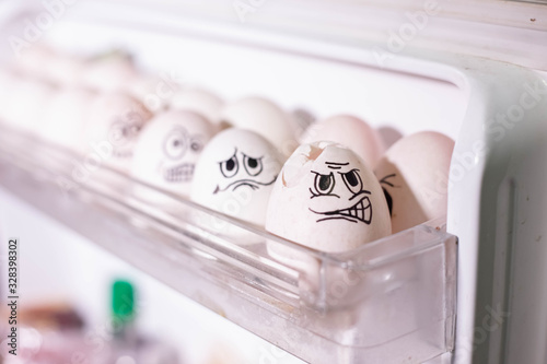 Emotionally eggs in the fridge tray. Real hand-painted eggs photo