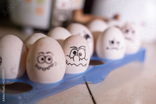 Emotionally eggs in the fridge tray. Real hand-painted eggs photo