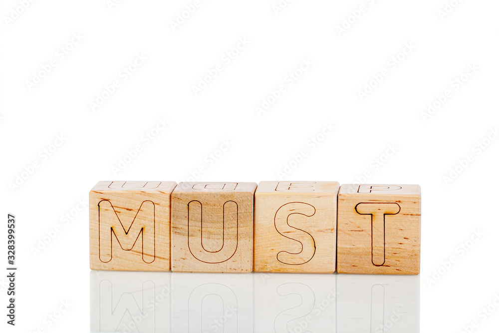 Wooden cubes with letters must on a white background