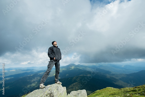 Young man on the top of the mountain