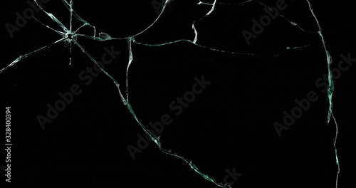 Broken cracks glass fracture effect texture isolated abstract black background. Bullet cracked window with big hole screen mirror weapon shot.