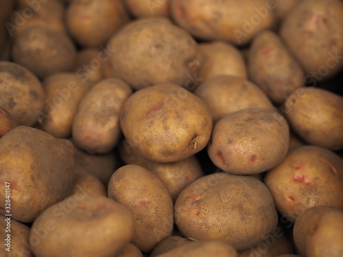 Fresh Organic Potato on Tray at the Farmer Market  Selective Focus.  A pile of organic potatoes lying in a tray. 