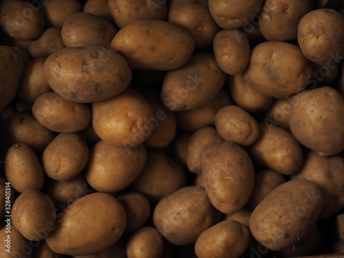 Fresh Organic Potato on Tray at the Farmer Market  Selective Focus.  A pile of organic potatoes lying in a tray. 