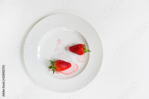 two red strawberry on white plate background