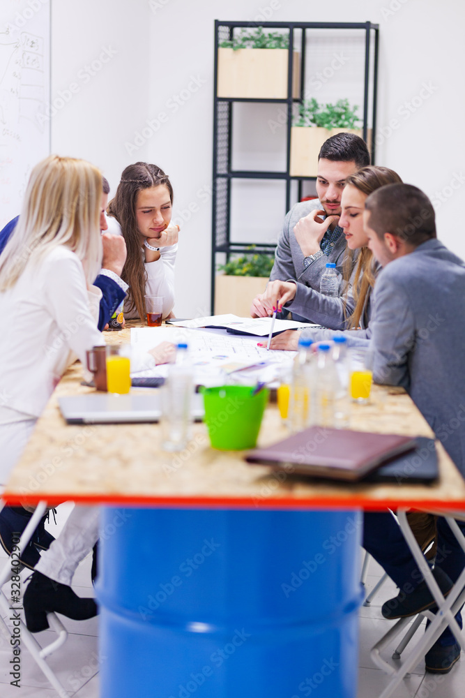 group of successful young architects in modern workplace, having a creative meeting. group of successful young architects in modern workplace, having a creative meeting.
