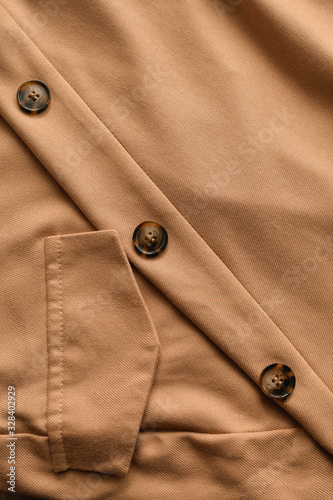 Detail of light beige skirt fabric with a pocket fragment.