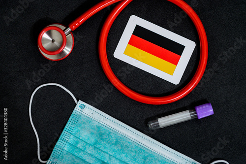 Coronavirus in Germany, Europe, surgical mask with coronavirus, Respiratory, test tube and Germany, Deutschland national flag photo