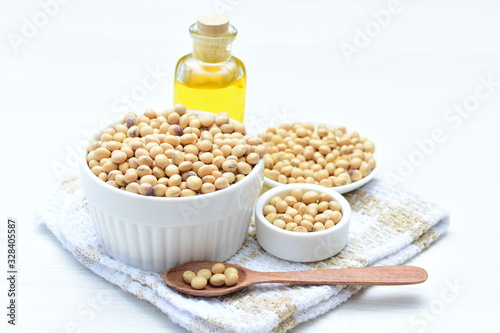 Raw soybeans (Glycine max) displayed in containers and accompanied by oil