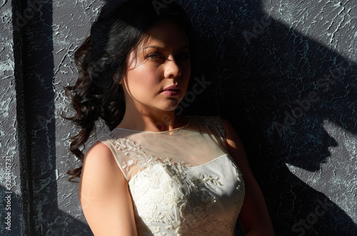 brunette bride in wedding dress looks at the camera