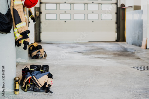 Boots and fireman's jacket on the garage floor of a fire station. photo