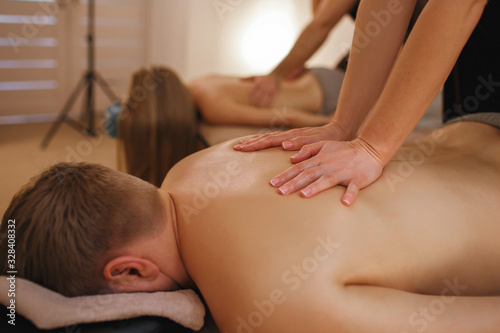 Man and woman relax in the spa, professional masseurs make massage, family vacations in the spa