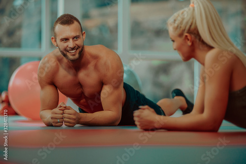 People sitting on the floor and having a break in the gym