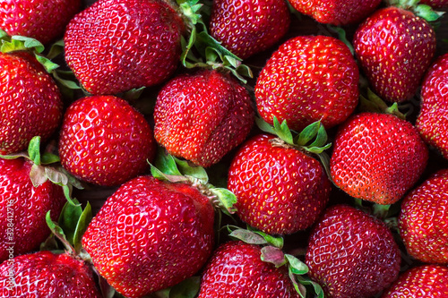 Beautiful fresh and juicy strawberry background. Real fruit close up. Ripe strawberry texture.