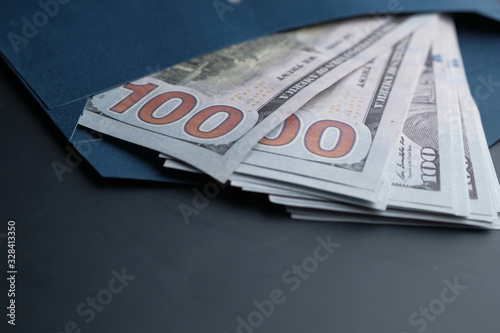 Close up of 100 dollar cash in envelope 