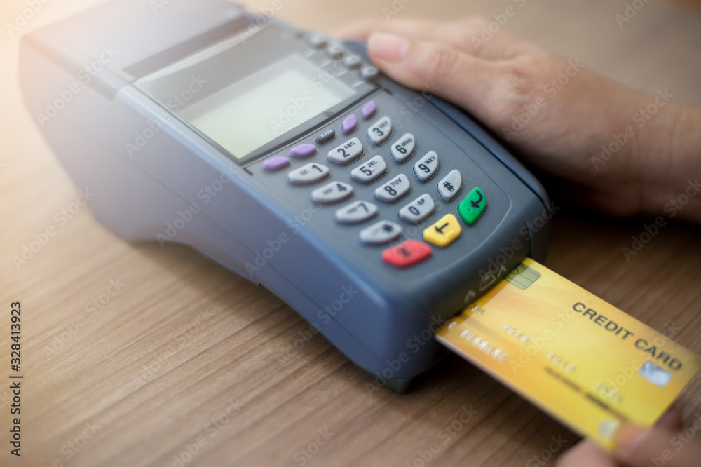 Hand Swiping Credit Card moment in-store of payment buy and sell products & service. Credit Card swipe machine. Hand Swiping Credit Card moment in-store of payment buy and sell products & service. Credit Card swipe machine.