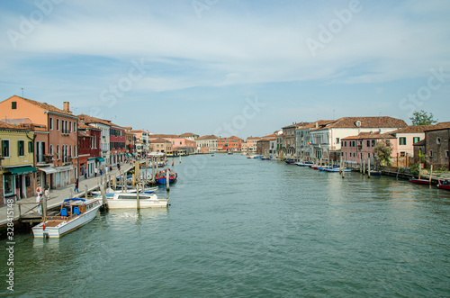 Venice, Italy May 18, 2015: View of beautiful canals and boats docked alongside the walkways in Venice Italy © ujjwal