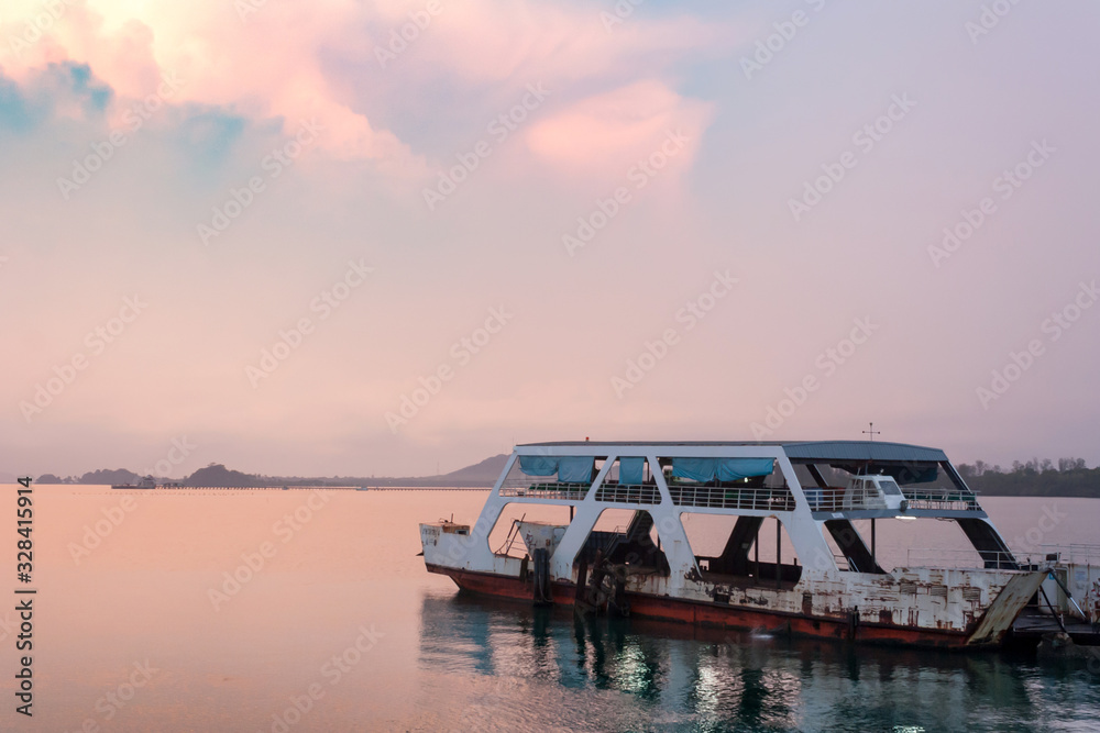 Old Ferry boat parked at pier in early morning, visible rain cloud. Clouds are beautiful. Old Ferry boat parked at pier in early morning, visible rain cloud. Clouds are beautiful.