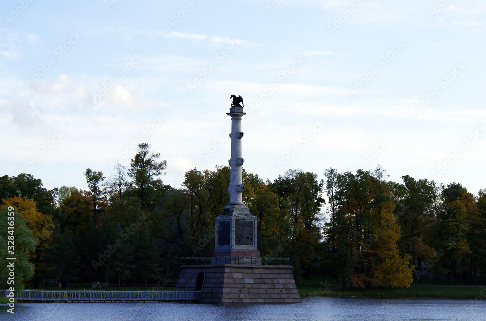 Fototapeta premium Autumn park with a lake and architecture.