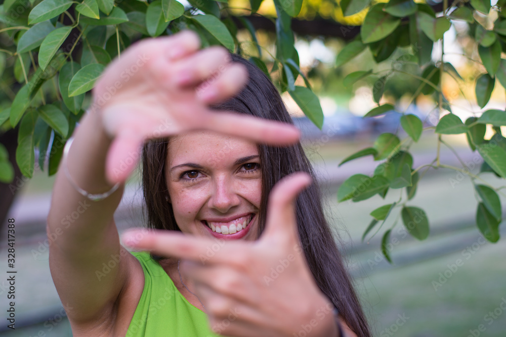 Woman portrait outdoors with green shirt in summer Woman portrait outdoors with green shirt in summer