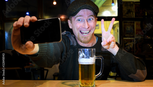 Guy and phone in the bar