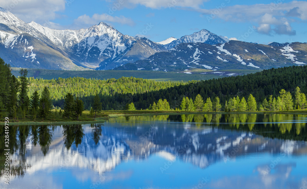 Wild mountain lake in the Altay mountains. Summer landscape, beautiful reflection. Travels in Russia.
