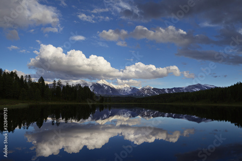 Lake in a mountain valley, summer in the mountains, sky reflection, Altai
