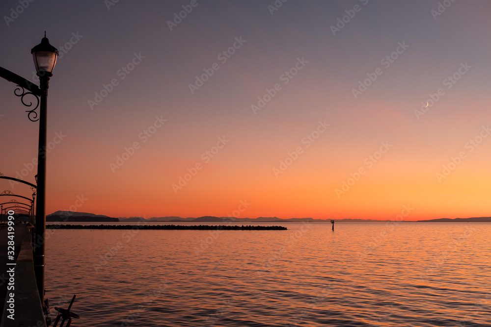 White Rock pier, breakwater and San Juan Islands during sunset