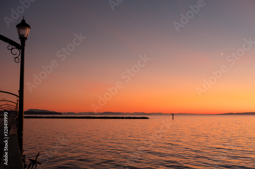 White Rock pier, breakwater and San Juan Islands during sunset