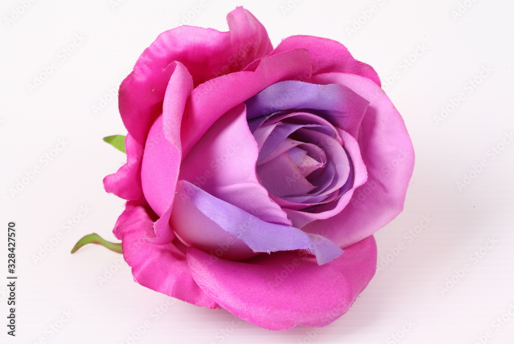 Artificial violet roses on white background Artificial violet roses on white background