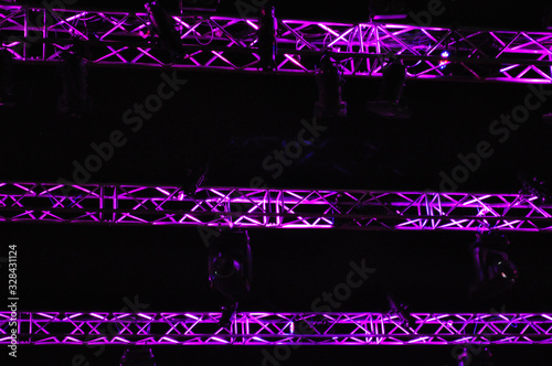 Stage metal truss during show with purple light reflection