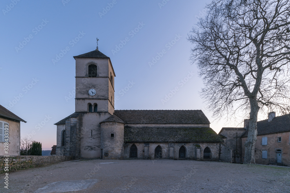 Ancient medieval building and church at dusk in a French town