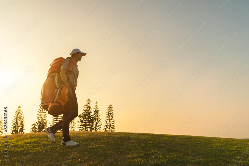 Blurred images of golfers who walking and carrying golf bags in the golf club.