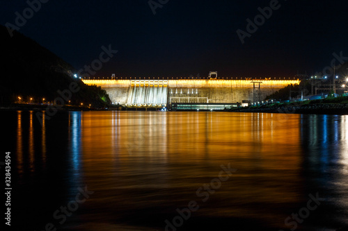 Industrial photography. General view of the Zeya Dam at night. Beautiful backlight hydroelectric power station.