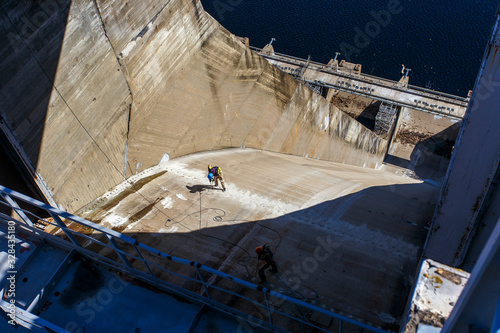 Industrial photography. Closed locks of Zeya hydroelectric power station against the background of calm blue water.