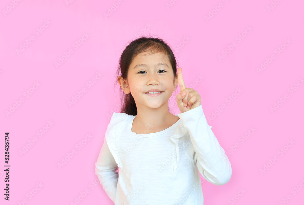 Portrait of smiling asian little child girl showing one forefinger isolated over pink background. Portrait of smiling asian little child girl showing one forefinger isolated over pink background.