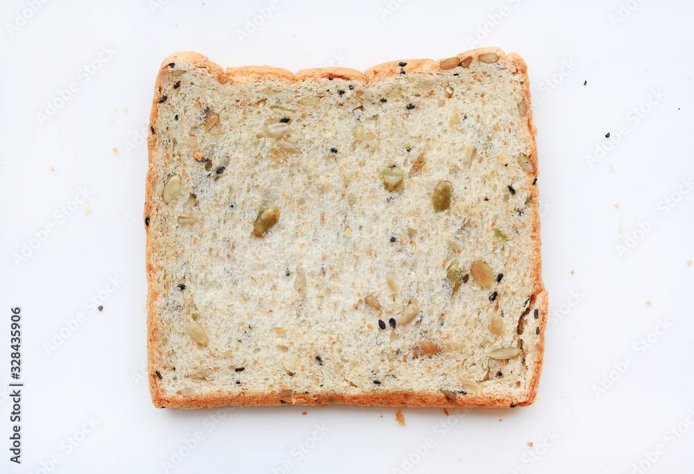 Sliced whole grain bread with seeds isolated on white background. Top view.