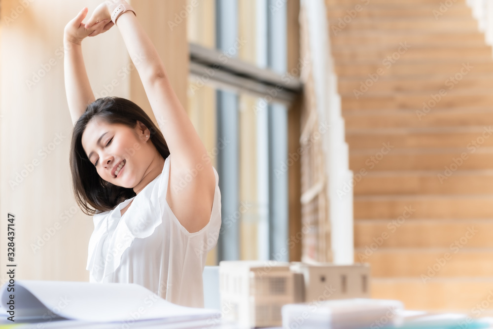 Business Asian woman relaxing with hands behind her head and sitting on an office chair.Time to relax. Business Asian woman relaxing with hands behind her head and sitting on an office chair.Time to relax.