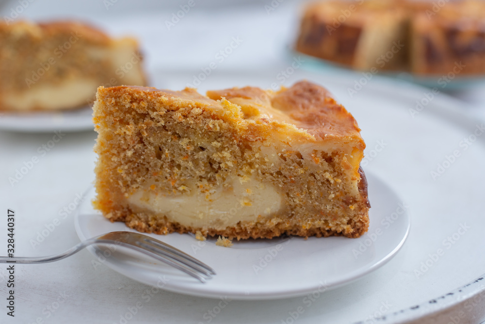 home made carrot cake cheesecake on a table