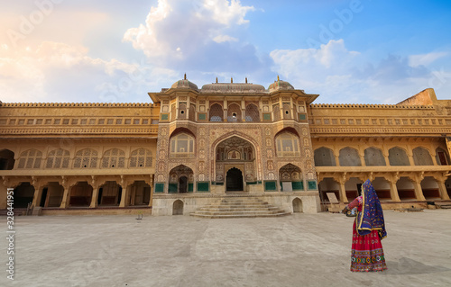 Woman in traditional outfit at historic Amer Fort at Jaipur Rajasthan India