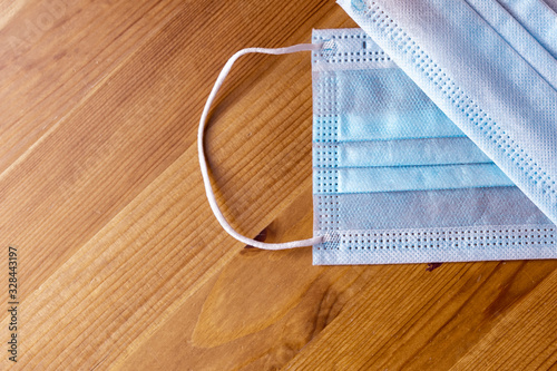 2 medical masks on a wooden background. virus and allergy protection photo