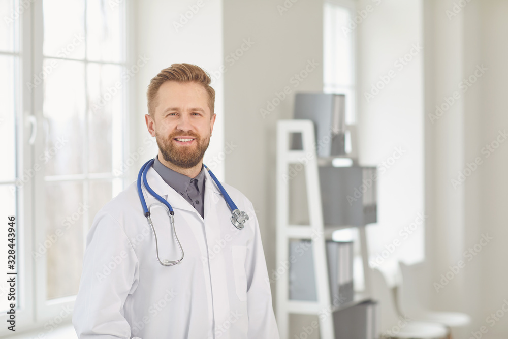Male doctor pediatrician standing in the white office of the hospital. Male doctor pediatrician standing in the white office of the hospital.